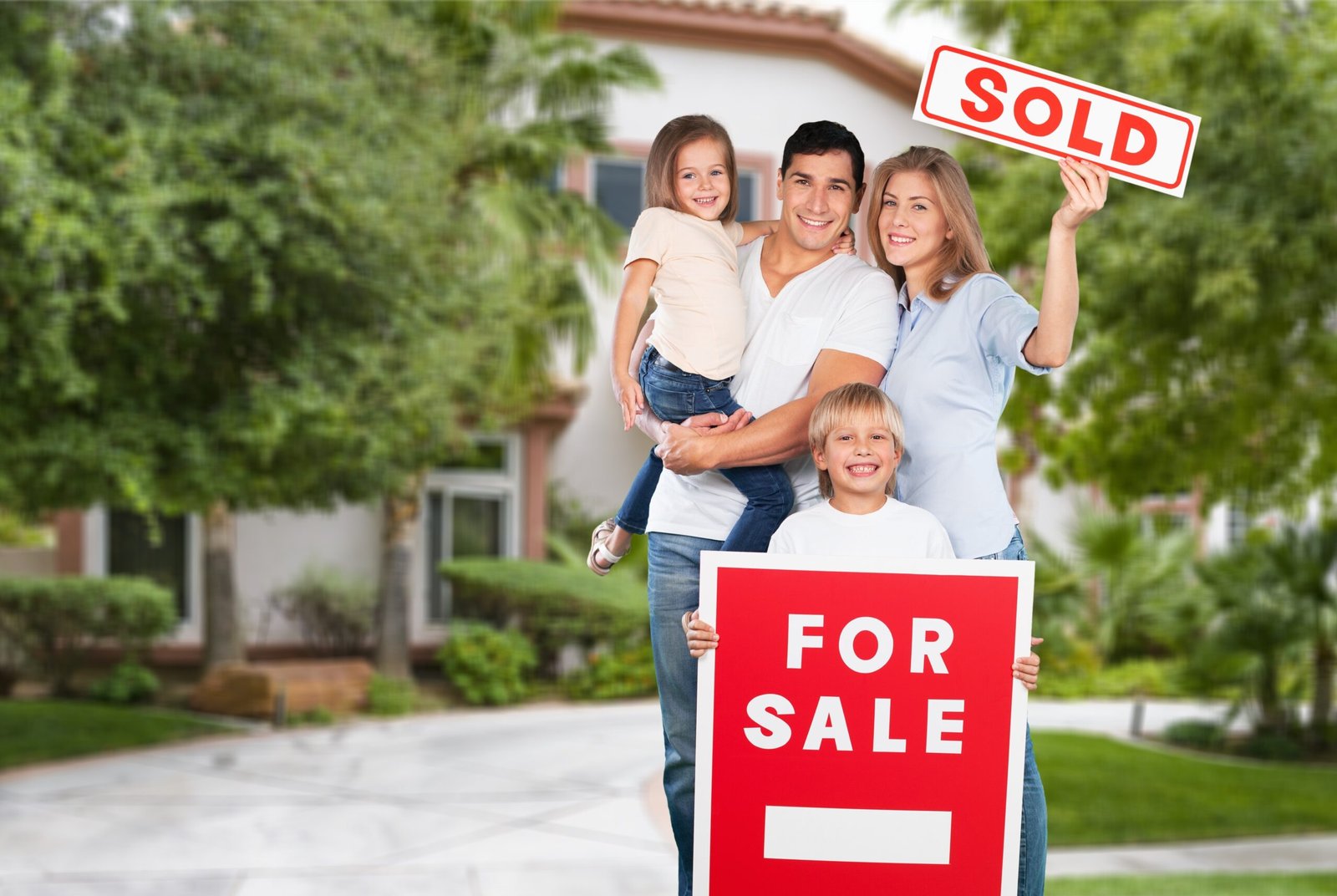 happy family of four with for sale sign