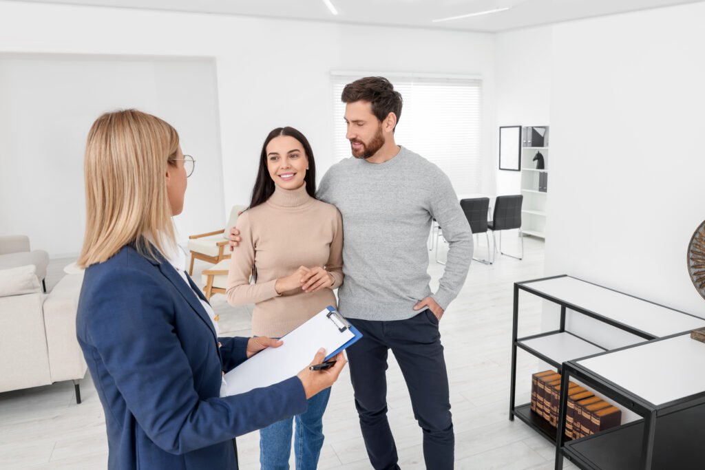 real estate agent showing new apartment to couple